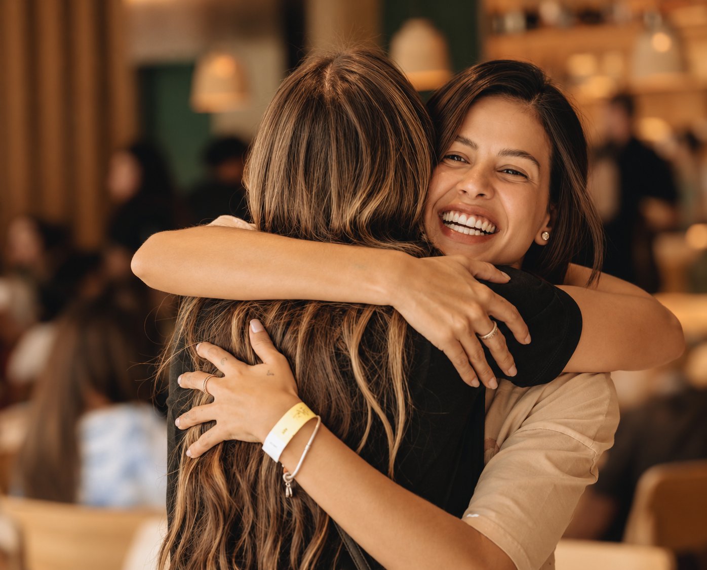 Duas colegas se abraçando, sorrindo, depois de uma experiência da Elarah